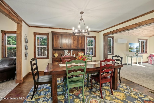 dining room with baseboards, dark wood-style flooring, a chandelier, and a healthy amount of sunlight