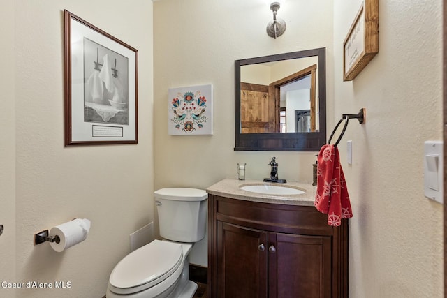 bathroom featuring toilet and vanity