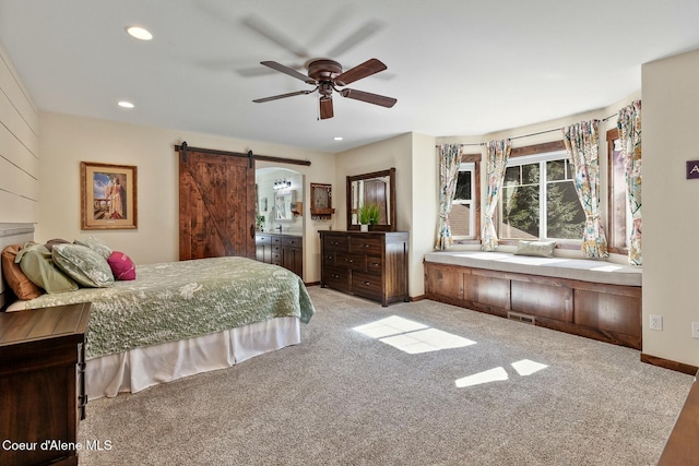 bedroom with carpet floors, recessed lighting, visible vents, a barn door, and baseboards