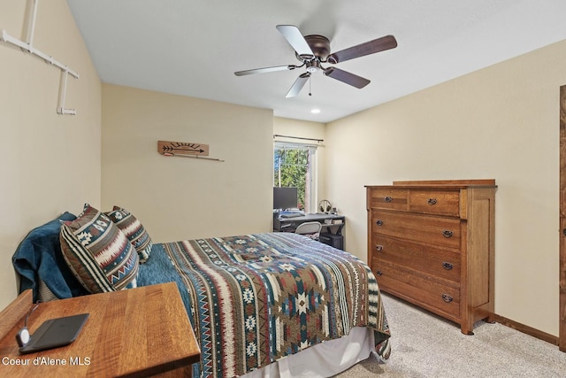 carpeted bedroom with a ceiling fan and baseboards