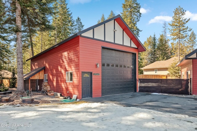 detached garage featuring fence