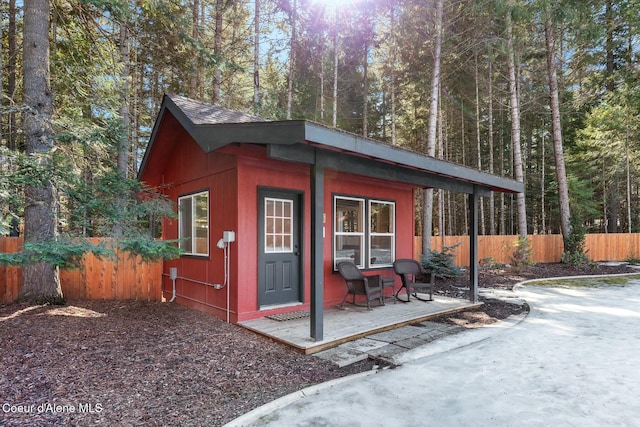 view of outbuilding with fence and an outdoor structure