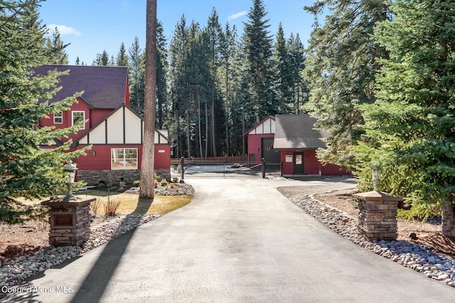 view of street featuring driveway and a gated entry