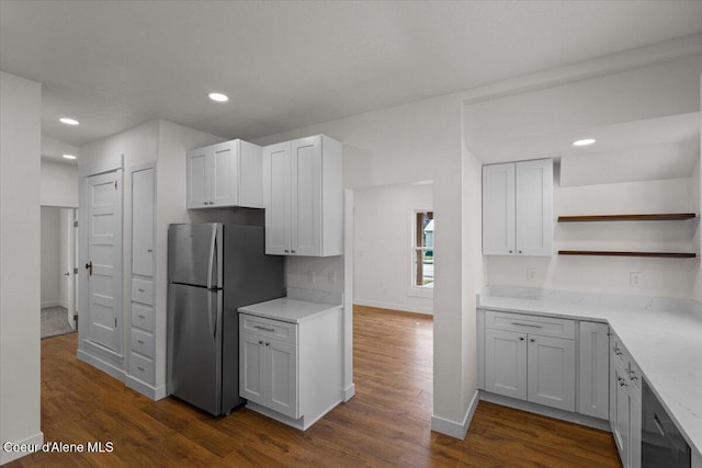 kitchen featuring baseboards, open shelves, dark wood finished floors, and freestanding refrigerator