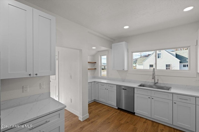 kitchen with recessed lighting, a sink, stainless steel dishwasher, and wood finished floors