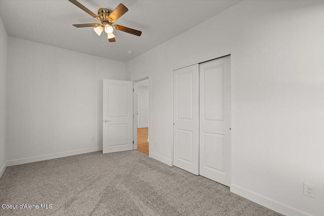 unfurnished bedroom with ceiling fan, a closet, carpet flooring, and baseboards