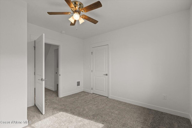 unfurnished bedroom featuring baseboards, visible vents, a ceiling fan, and light colored carpet