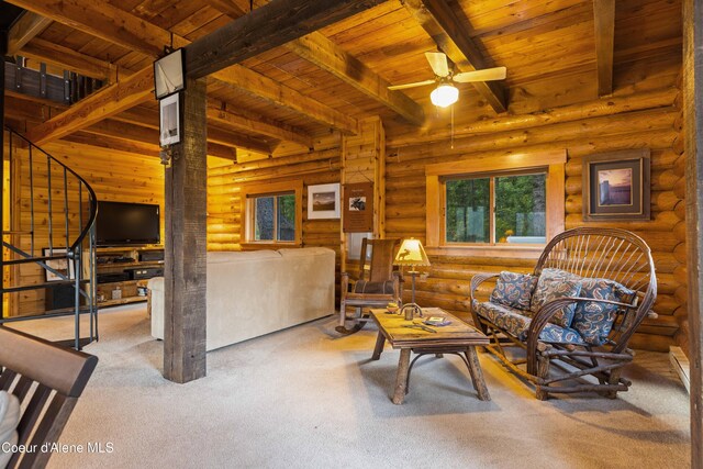 living area featuring carpet, wood ceiling, ceiling fan, beamed ceiling, and stairs