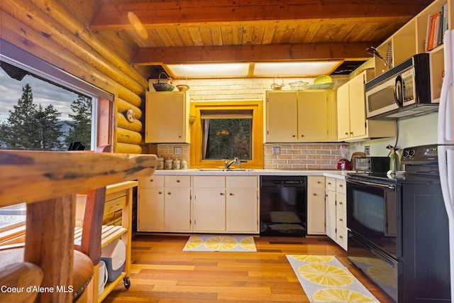 kitchen with rustic walls, a sink, light countertops, black appliances, and beam ceiling