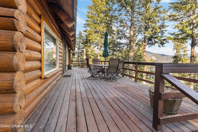 deck featuring a mountain view and outdoor dining area