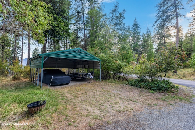 view of parking / parking lot with driveway and a carport