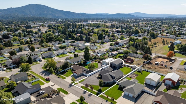 drone / aerial view featuring a residential view and a mountain view