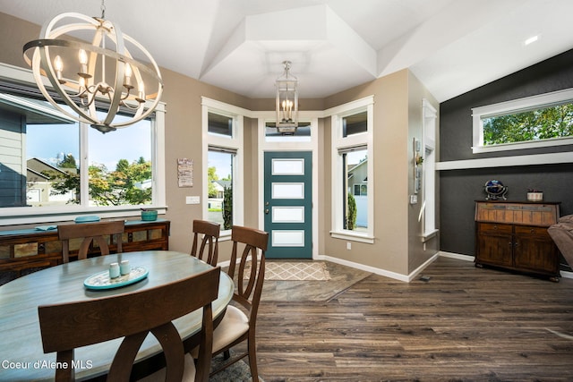 dining room featuring an inviting chandelier, baseboards, dark wood-type flooring, and vaulted ceiling