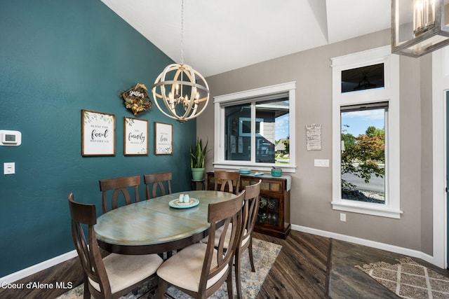 dining area with a notable chandelier, lofted ceiling, baseboards, and wood finished floors