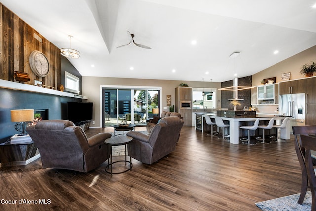 living room featuring dark wood finished floors, recessed lighting, high vaulted ceiling, and ceiling fan