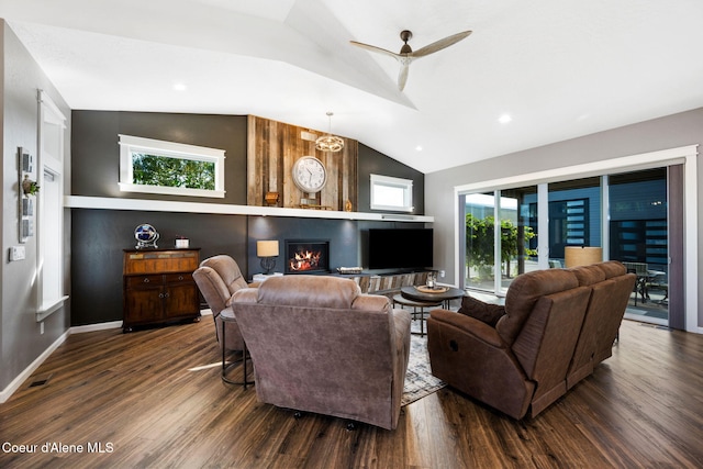 living room with baseboards, dark wood finished floors, ceiling fan, vaulted ceiling, and a large fireplace