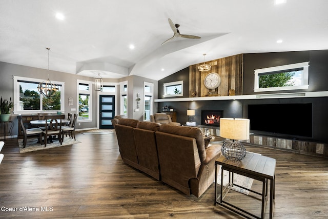 living area featuring recessed lighting, a large fireplace, lofted ceiling, and wood finished floors