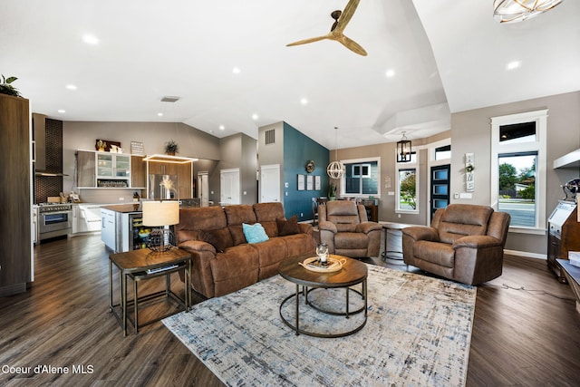 living area featuring dark wood finished floors, lofted ceiling, baseboards, and visible vents