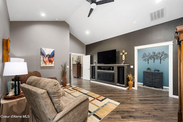 living area with wood finished floors, baseboards, visible vents, a fireplace, and ceiling fan