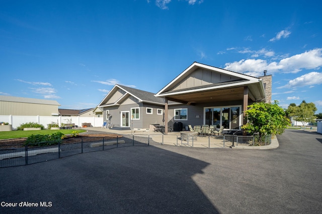 back of house featuring a patio area, board and batten siding, and a fenced backyard