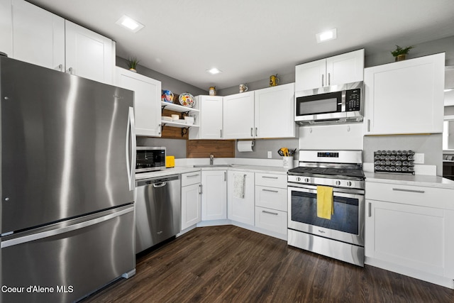 kitchen with open shelves, white cabinets, light countertops, and appliances with stainless steel finishes