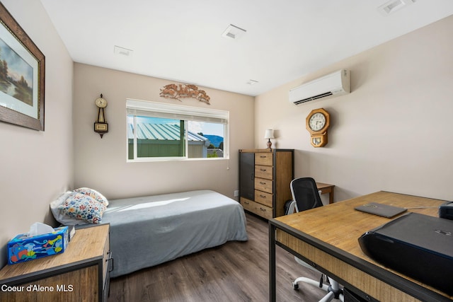 bedroom with an AC wall unit, visible vents, and dark wood-style flooring