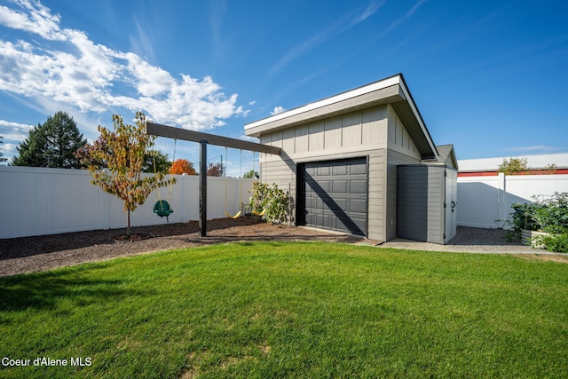 exterior space featuring an outbuilding, a fenced backyard, and a garage