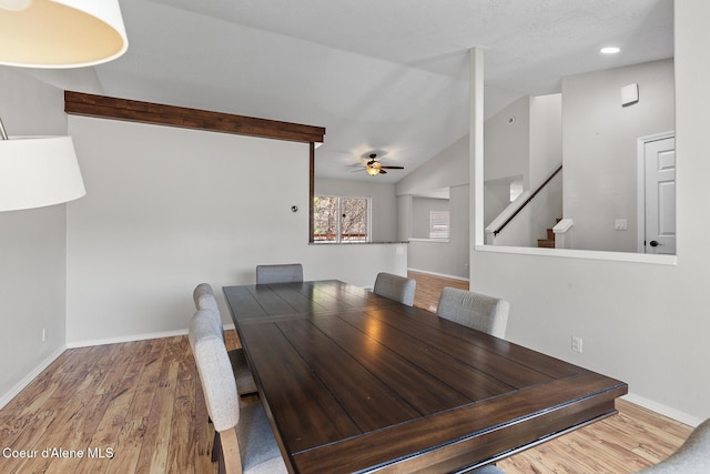 unfurnished dining area with vaulted ceiling with beams, ceiling fan, wood finished floors, and baseboards