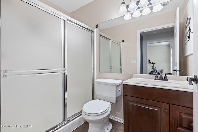 bathroom with a stall shower, vanity, and toilet