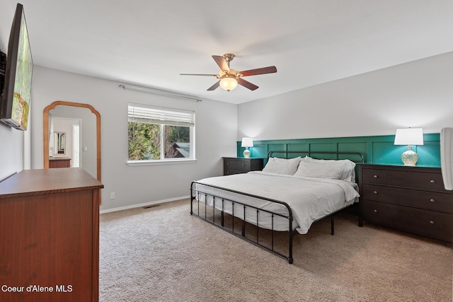 bedroom featuring a ceiling fan, carpet flooring, visible vents, and baseboards