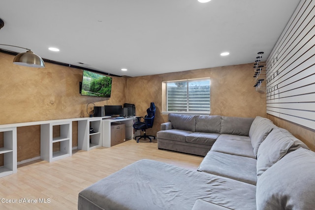 living room with built in desk, wood finished floors, and recessed lighting