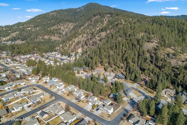 birds eye view of property with a residential view, a mountain view, and a view of trees