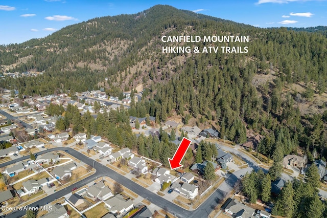 bird's eye view featuring a forest view, a residential view, and a mountain view