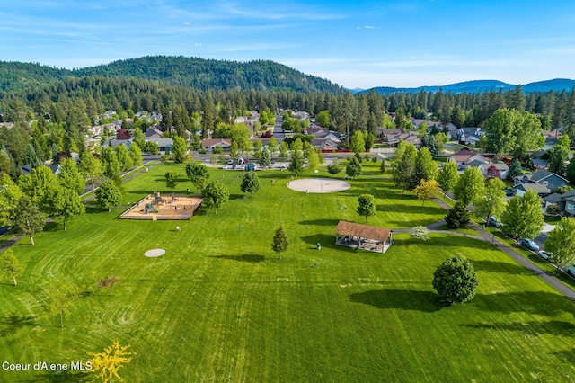 drone / aerial view with a mountain view and a view of trees