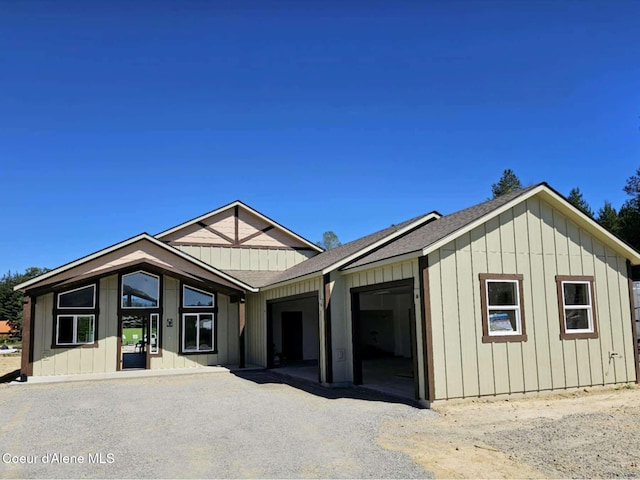 105 Backtrack Rd, Sandpoint, ID 83864 - view of front facade with a garage, board and batten siding, and roof with shingles