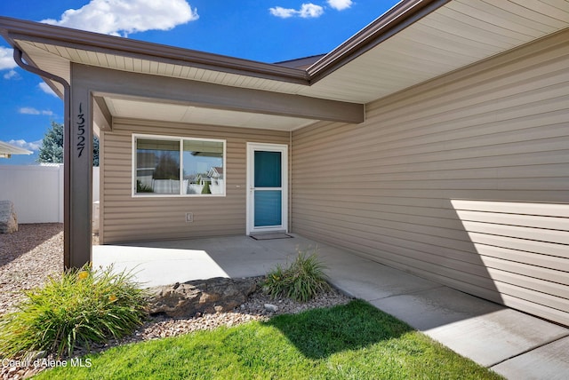 doorway to property with a patio area and fence