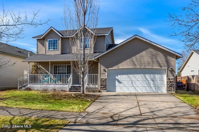 traditional-style home with fence, a porch, concrete driveway, a front lawn, and a garage