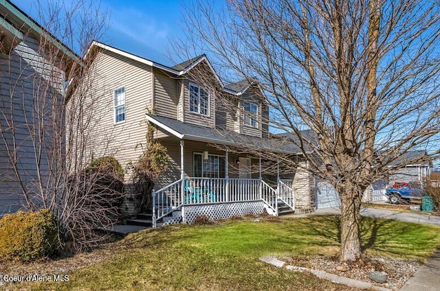 view of front of house featuring a porch, a front lawn, and driveway