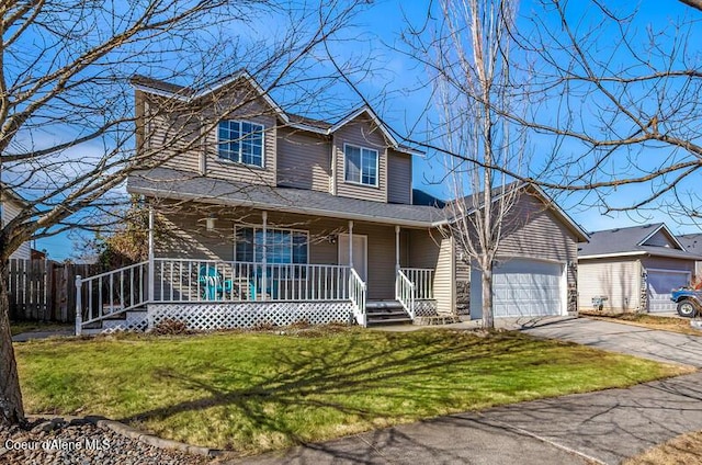 traditional-style home with a front lawn, a porch, fence, concrete driveway, and an attached garage