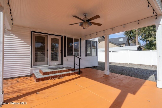 view of patio / terrace with a ceiling fan and fence