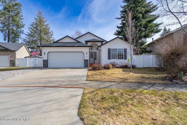 ranch-style house featuring brick siding, fence, concrete driveway, an attached garage, and a gate