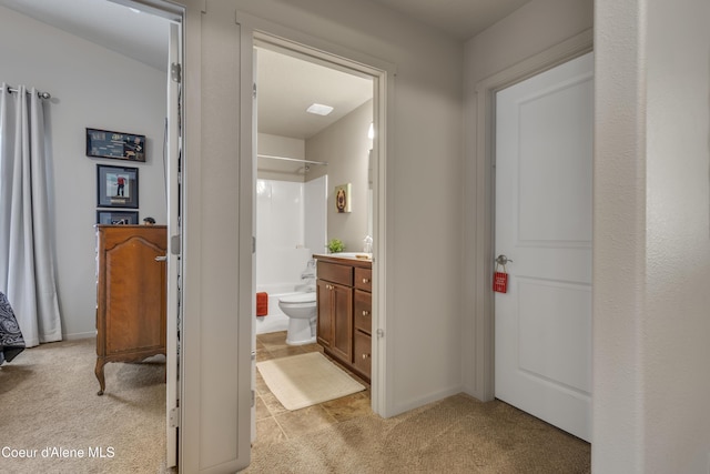 bathroom with toilet, vanity, and shower / tub combination