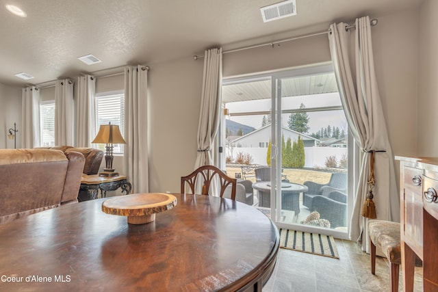 dining area featuring visible vents and a textured ceiling