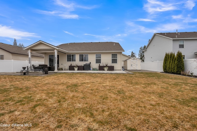 rear view of house featuring a patio area, a lawn, and a fenced backyard