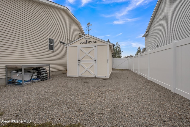 view of shed featuring a gate and fence