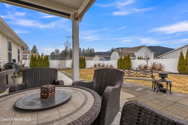 view of patio with area for grilling and a fenced backyard