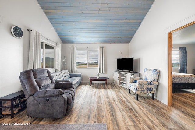 living area with vaulted ceiling, wood finished floors, and wood ceiling