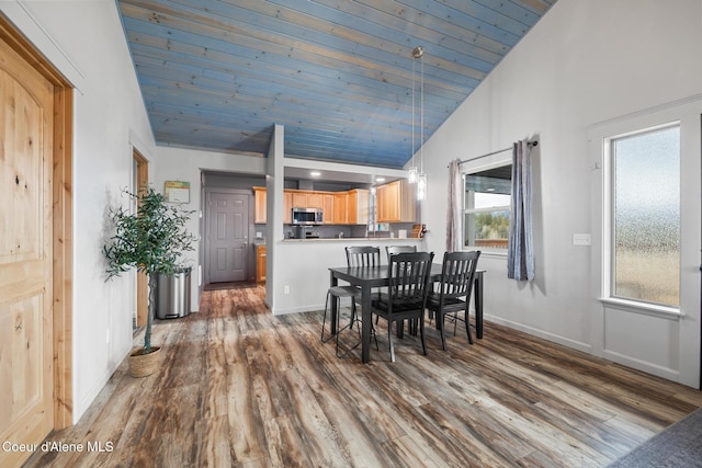 dining space featuring baseboards, high vaulted ceiling, wood finished floors, and wooden ceiling