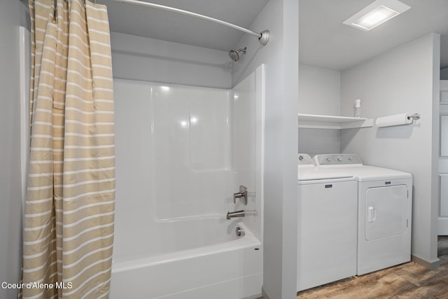 full bathroom featuring shower / bath combo, washer and clothes dryer, and wood finished floors