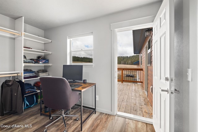 home office featuring baseboards and wood finished floors